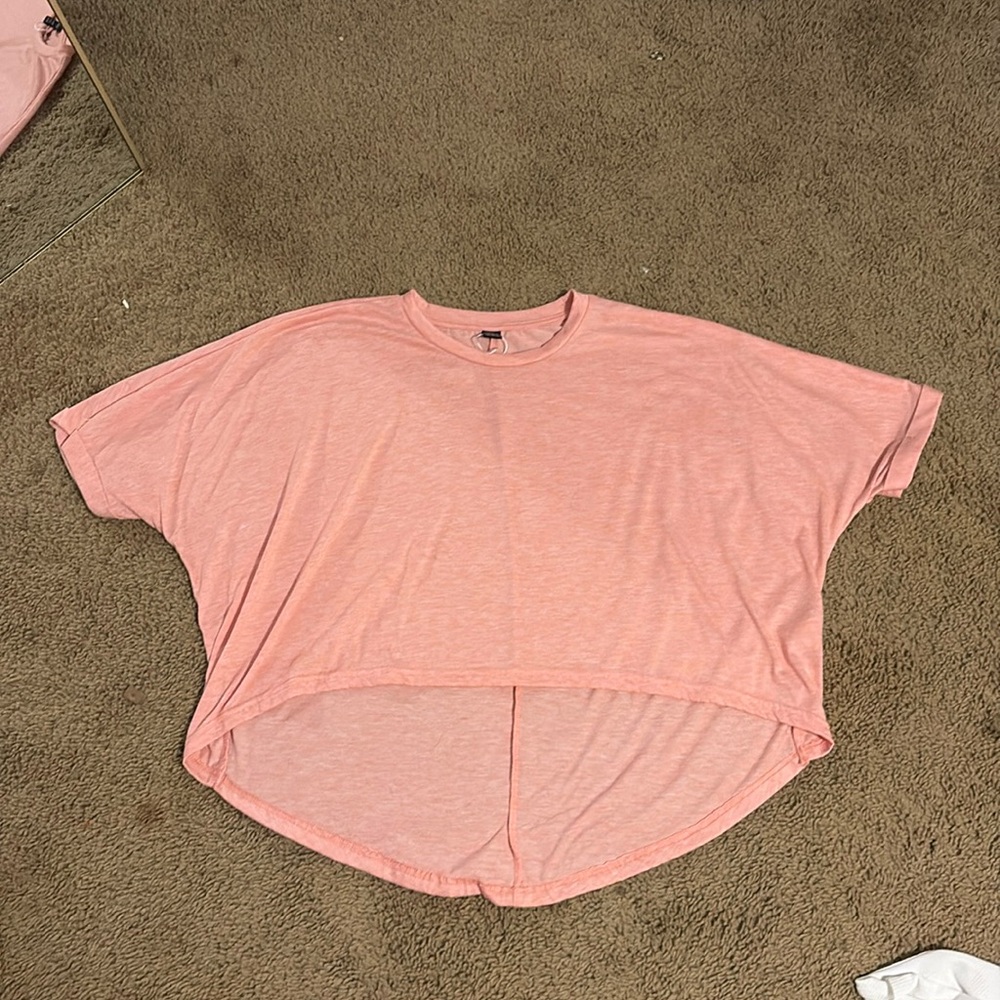 This is a pink baggy cropped shirt.